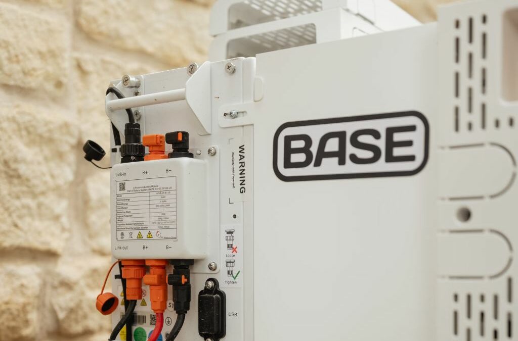 A Base Power battery sits next to a home.