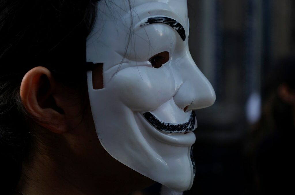 A member of the international organisation Anonymous for the Voiceless wears a Guy Fawkes mask while demonstrating in the streets of Mexico City's Historic Center.