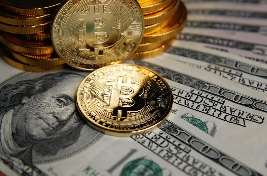 Bitcoin coins cryptocurrency on U.S. dollar banknotes background.