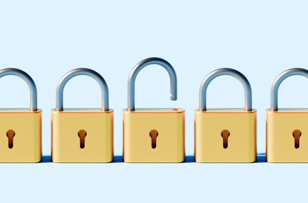 Conceptual stock image depicting a linear row of identical padlocks, all securely locked except for one that is open.