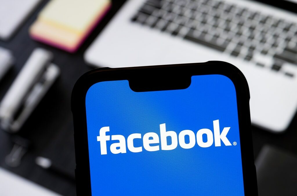 photo illustration of Facebook logo is seen displayed on a smartphone.