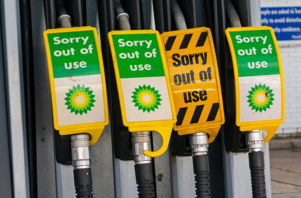 Signs warn drivers that gas pumps are out of order.