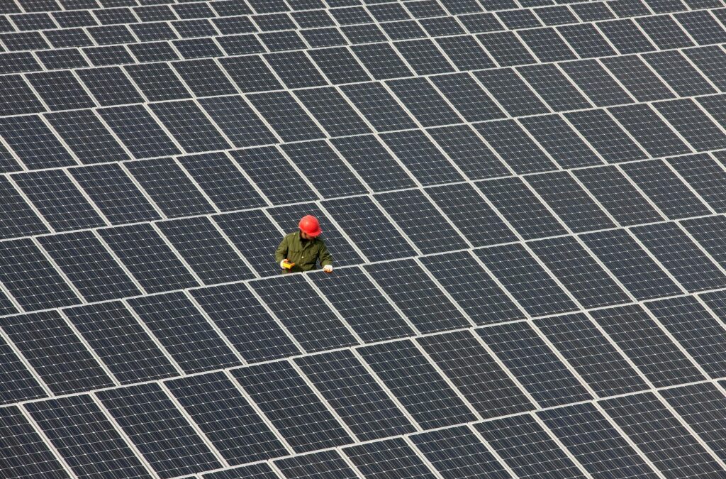 Man inspecting solar panels.