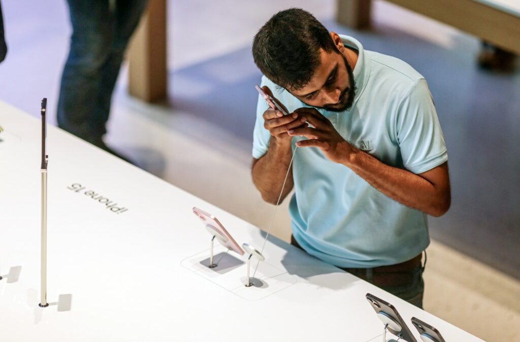 man checking out retail cell phone display