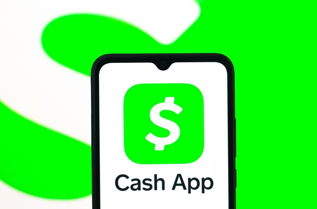In this photo illustration, the Cash App logo is seen displayed on a smartphone screen.