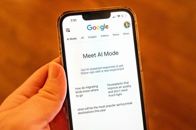 gettyimages-2206888090 A person holding an iPhone and using Google AI Mode