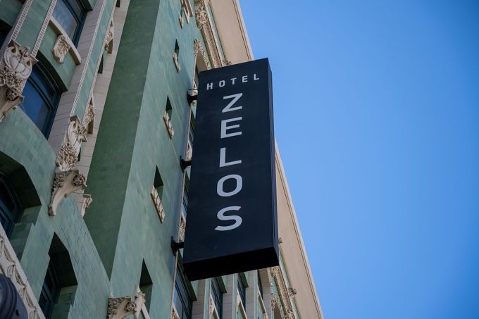 gettyimages-2231031292 Vertical sign for Hotel Zelos on green tiled historic facade under clear blue sky, San Francisco, California, August 19, 2025.