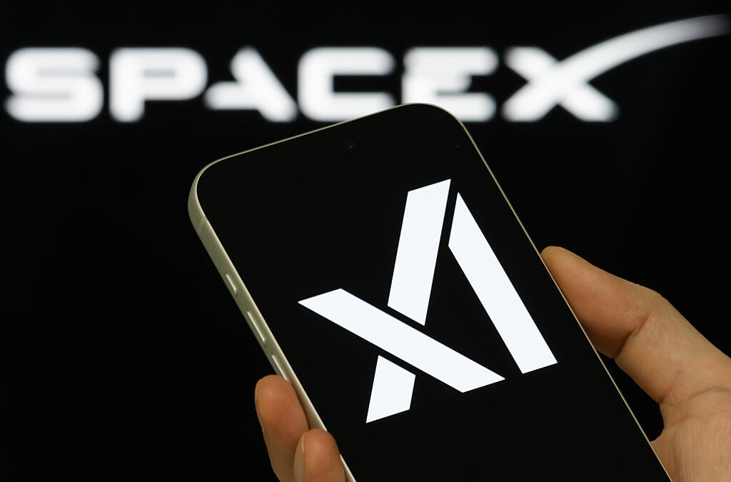xAI Logo Shown On Smartphone With SpaceX Branding In Background