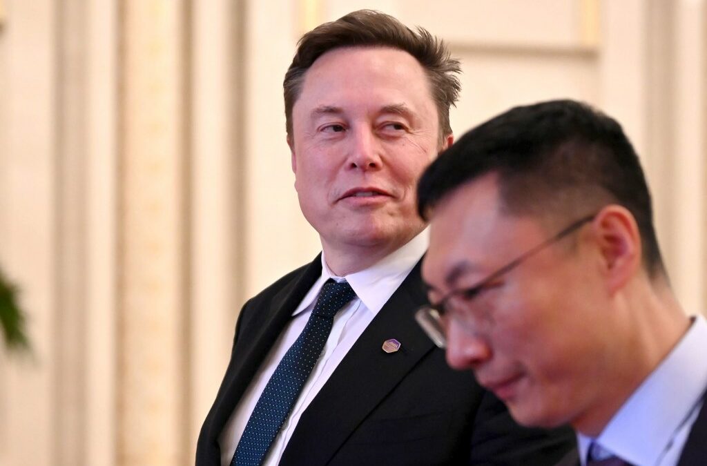 Tech billionaire and Tesla founder Elon Musk walks through the Great Hall of the People.