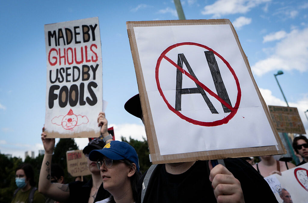 A sign opposed to AI is held during a protest against AI data centers in Vancouver, British Columbia, Canada, on Saturday, June 27, 2026. Canadians aren't universally sold on building sovereign compute, with early signs of protest against AI server farms in British Columbia and Manitoba. Photographer: Ethan Cairns/Bloomberg via Getty Images