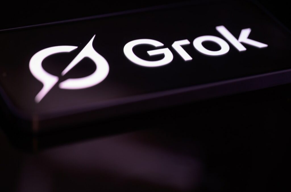The Grok logo is displayed on a mobile phone screen