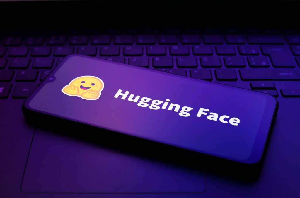 The Hugging Face logo appears on the screen of a smartphone.