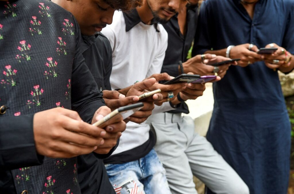Internet users in India looking at their smartphones