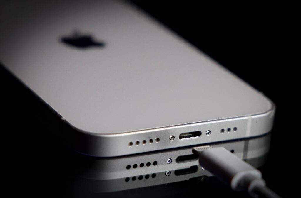 A Apple Lightning port charging cable is seen with with an iPhone.