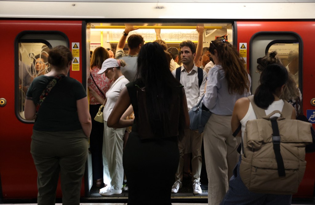 Commuters travel on a London Underground tube carriage, during a heatwave, in central London on June 24, 2026.