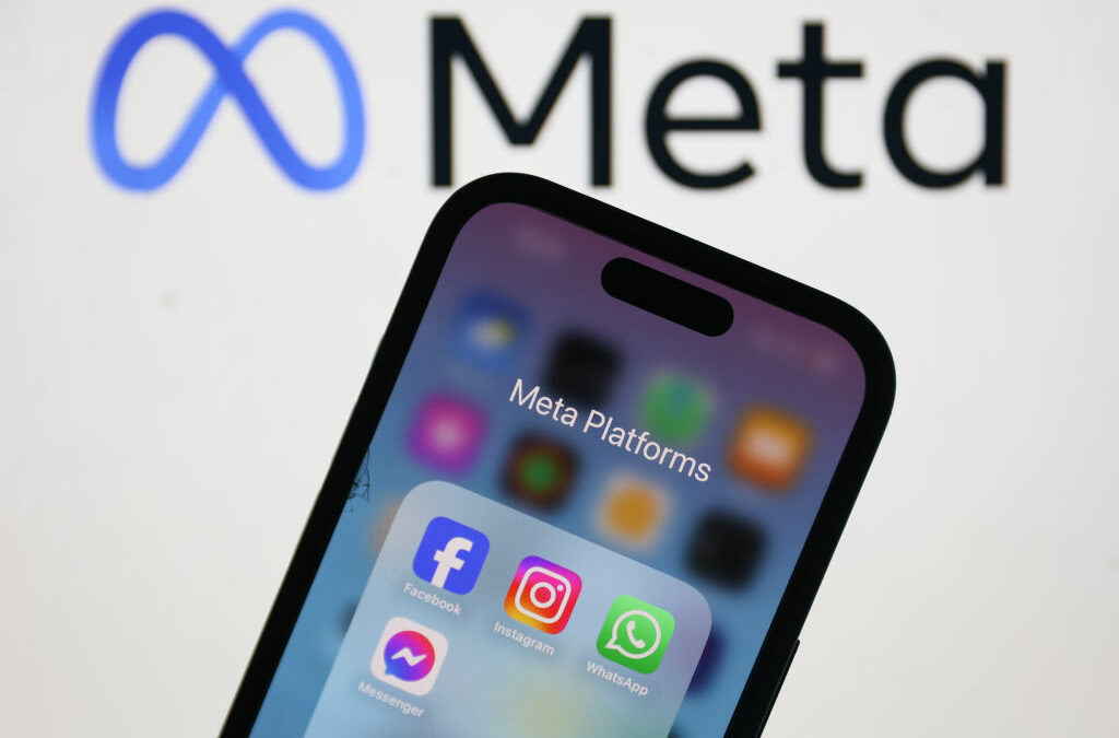 Meta logo displayed on a laptop screen and Facebook, Instagram, WhatsApp and Messenger icons displayed on a phone screen are seen in this illustration photo.