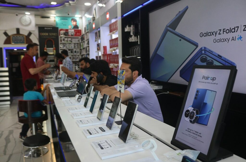 Samsung mobile phones are displayed for sale at an electronics store.