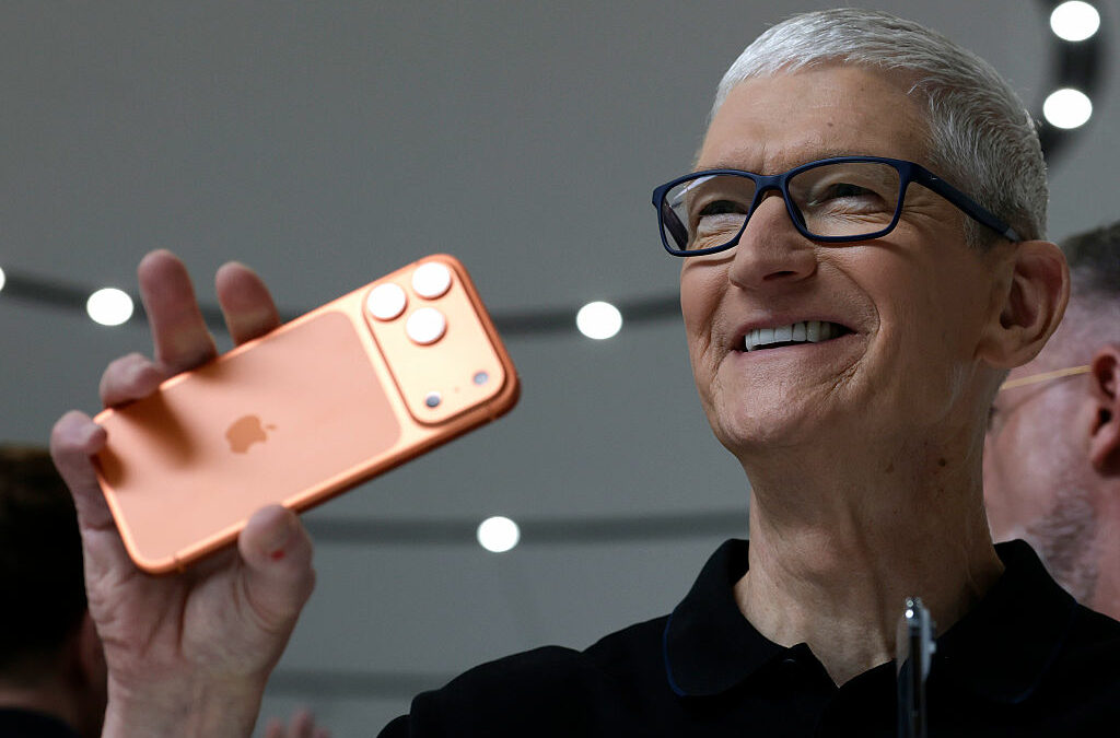 Apple CEO Tim Cook holds up a new iPhone 17 Pro