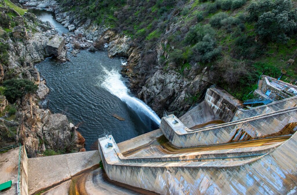 a photo of a dam in Spain seen spilling water.