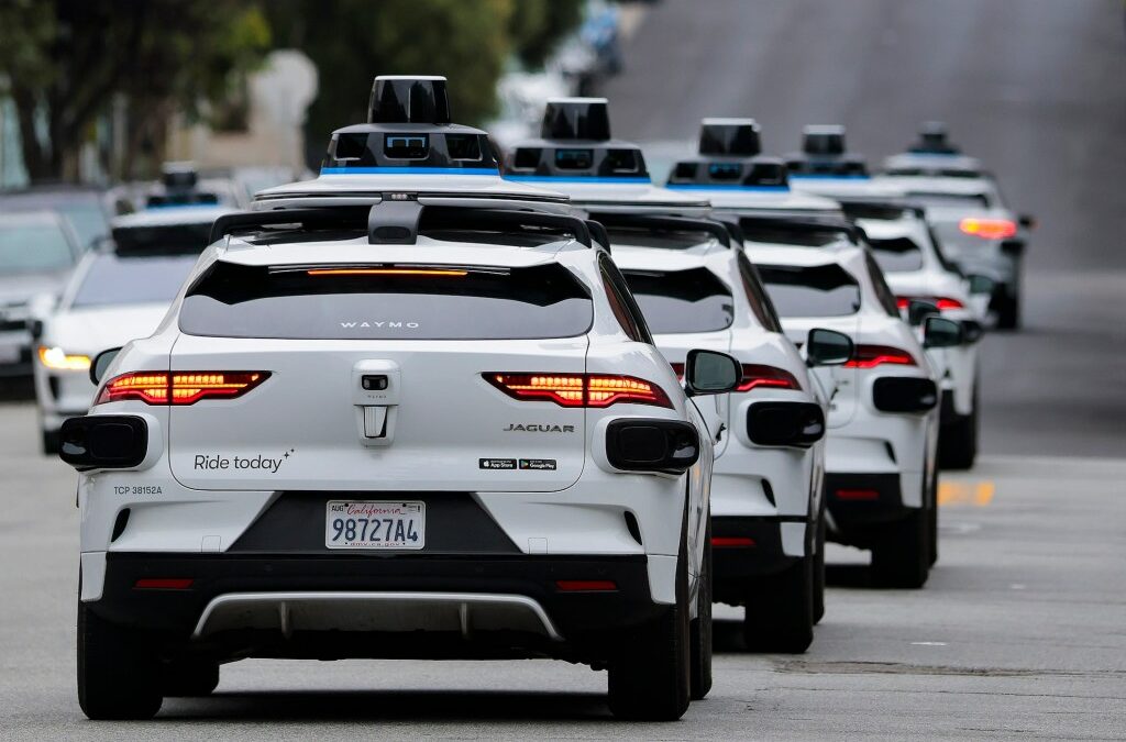 A line of Waymo robotaxis drives through North Beach on July 07, 2026 in San Francisco, California.